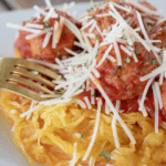spaghetti squash with turkey meatballs on a white plate ready to eat
